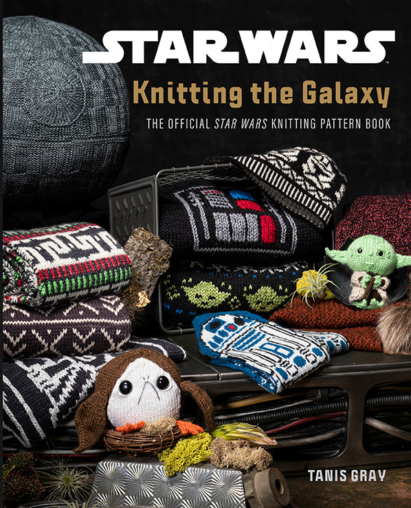 Hardcover book titled "Star Wars: Knitting the Galaxy" by Insight Editions, featuring a Star Wars-themed knitting guide and illustrations.