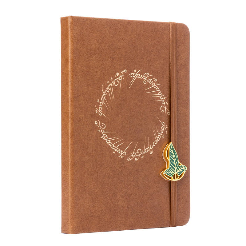 Hardcover The Lord of the Rings: One Ring journal with charm featuring iconic ring design and detailed cover artwork.