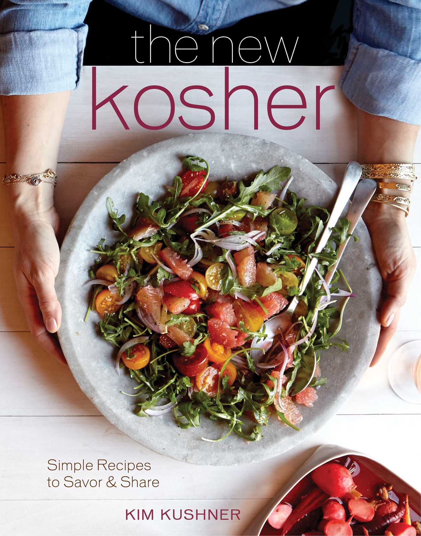 Hardcover copy of "The New Kosher" book by Insight Editions with a textured cover and title embossed on the front.