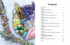 Open hardcover book titled "The Power of Crystal Healing" by Insight Editions, featuring colorful crystal illustrations inside.