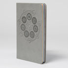 Open hardcover book titled "The Seven Chakras" by Insight Editions, showing colorful chakra illustrations on interior pages.