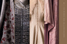 Hardcover book with jacket titled "Game of Thrones: The Costumes" by Insight Editions, featuring images of costumes from the series.