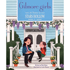 Hardcover book with jacket of "Gilmore Girls: At Home in Stars Hollow" by Insight Editions, featuring a cozy Stars Hollow scene.