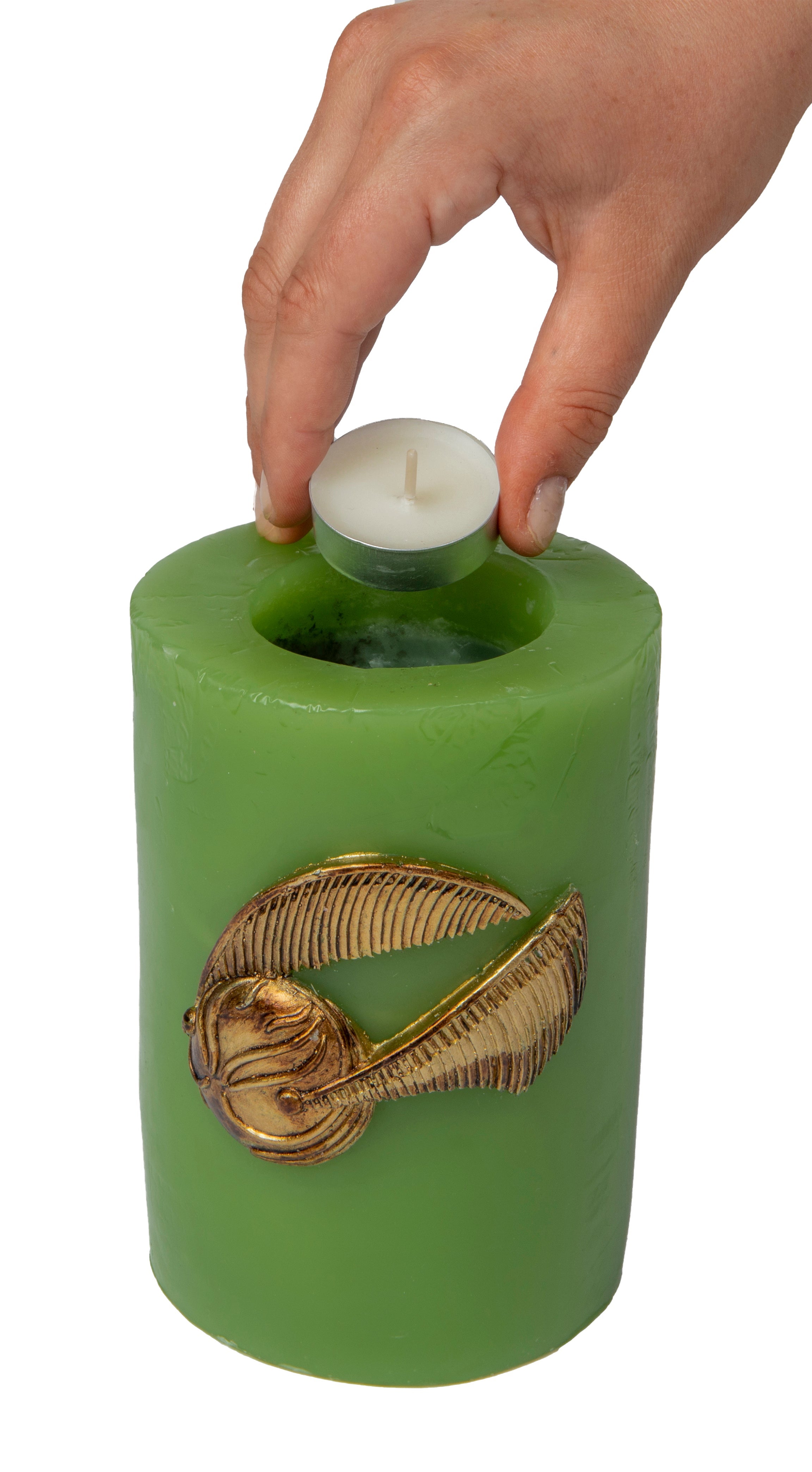Sculpted Harry Potter Golden Snitch insignia candle in a decorative home goods setting, designed by Insight Editions.