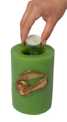Sculpted Harry Potter Golden Snitch insignia candle in a decorative home goods setting, designed by Insight Editions.