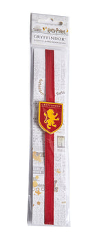 Gryffindor enamel charm bookmark from Harry Potter series with house crest in gold and red, ideal for marking pages in a book.