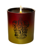 Gryffindor glass candle from Harry Potter home goods by Insight Editions, featuring a decorative glass container with Gryffindor emblem.