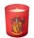Gryffindor scented glass candle from Harry Potter home goods set by Insight Editions, with a clear glass container and Gryffindor emblem.