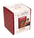Gryffindor scented glass candle from Harry Potter collection by Insight Editions, featuring a decorative glass container with Gryffindor emblem.