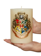 Harry Potter Hogwarts Insignia candle with sculpted Hogwarts crest, home decor from Insight Editions.