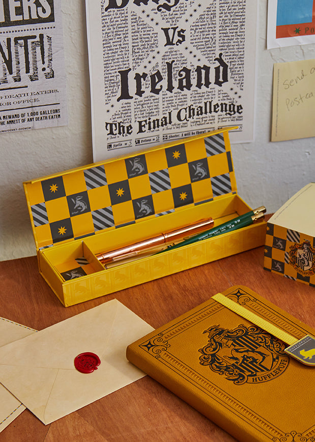 Hufflepuff magnetic pencil box from Harry Potter, Insight Editions home goods, featuring house crest and bright yellow design.