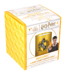 Hufflepuff scented glass candle from Harry Potter home goods collection, featuring a decorative Hufflepuff crest design.