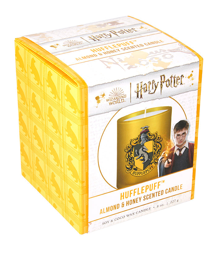 Hufflepuff scented glass candle from Harry Potter home goods collection, featuring a decorative Hufflepuff crest design.