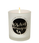 Harry Potter "Mischief Managed" glass votive candle in a decorative home goods display by Insight Editions.