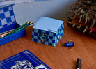 Harry Potter Ravenclaw Memo Cube by Insight Editions with blue and silver design featuring Ravenclaw emblem and magical details.