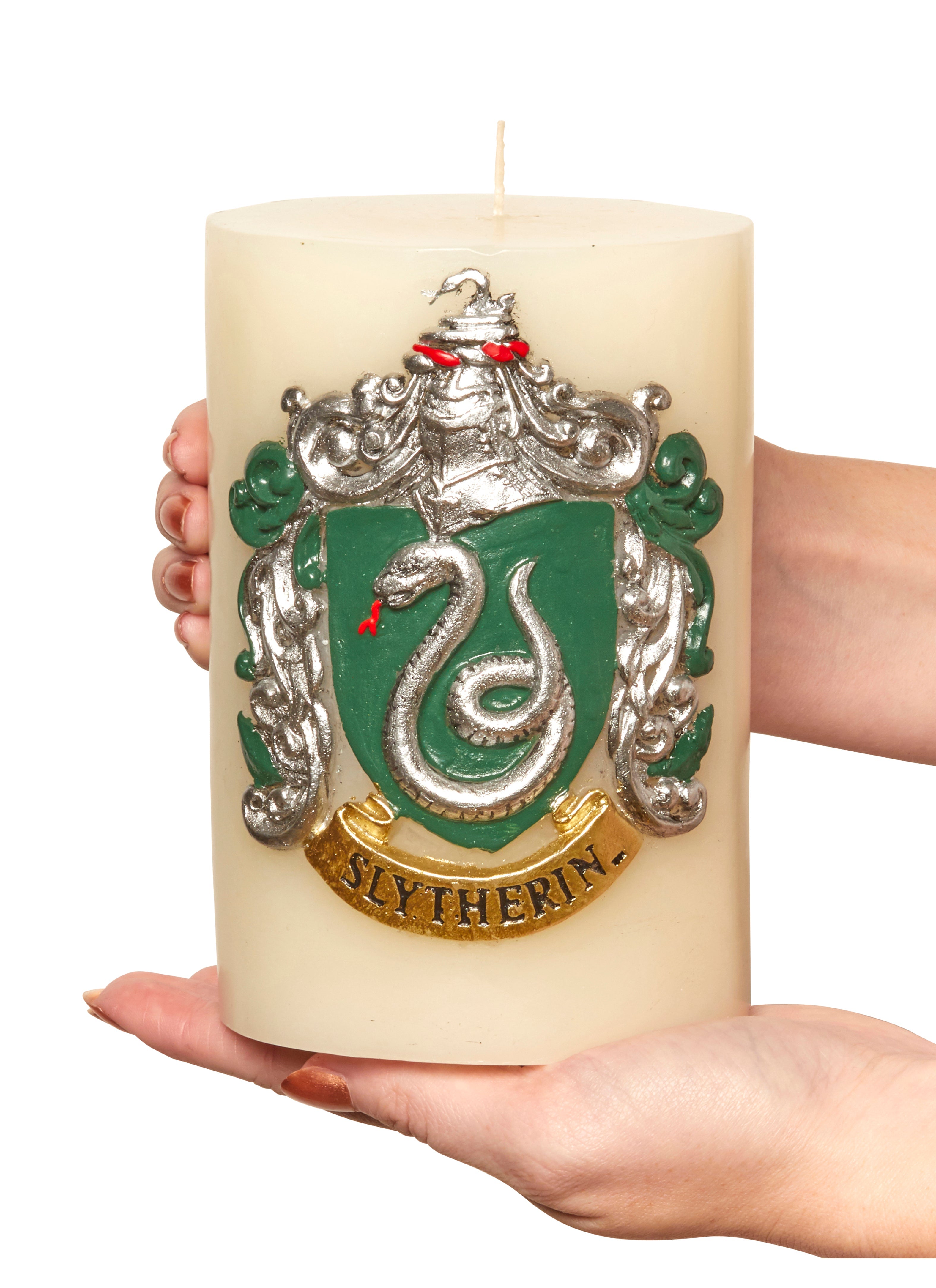 Harry Potter Slytherin sculpted insignia candle from Insight Editions, featuring detailed Slytherin house emblem on a decorative candle.