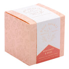 Rose quartz crystal healing scented glass candle on a wooden table, perfect for home decor and relaxation.