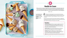 American Girl Let's Celebrate Cookbook Collection kit by Insight Editions, featuring colorful recipe pages and cooking tools.