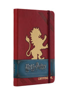 Harry Potter Gryffindor boxed gift set kit by Insight Editions with wand, badge, and themed collectibles displayed inside.