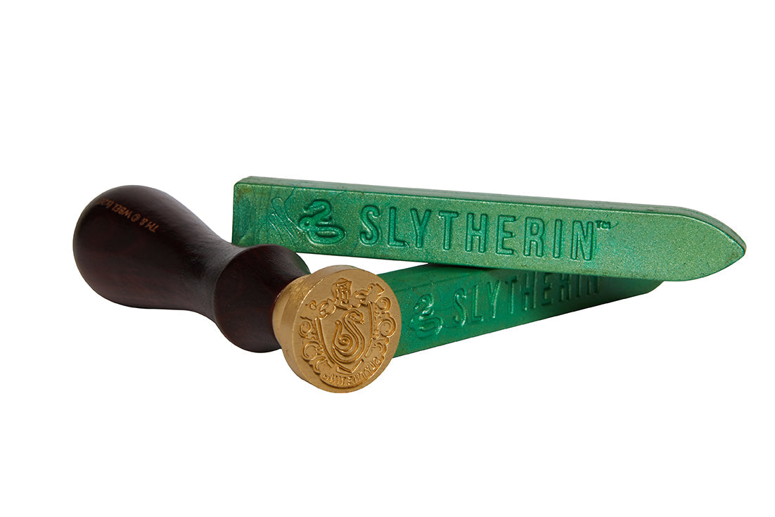 Harry Potter Slytherin wax seal set kit with green wax, Slytherin emblem, and sealing stamps from Insight Editions.