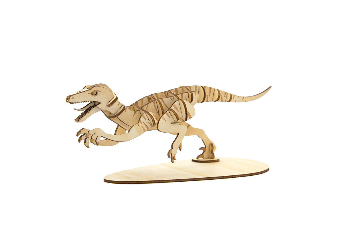 IncrediBuilds Jurassic World Raptor 3D wood model kit with accompanying book, featuring detailed raptor design from Insight Editions.
