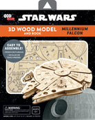 IncrediBuilds Star Wars Millennium Falcon 3D wood model kit with instructional book by Insight Editions displayed on a table.