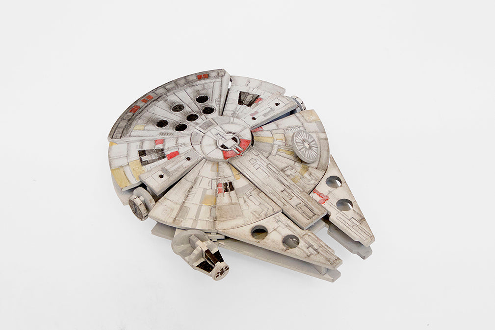 Insight Editions Star Wars Millennium Falcon 3D wood model kit with accompanying book, detailed model of the iconic spaceship.