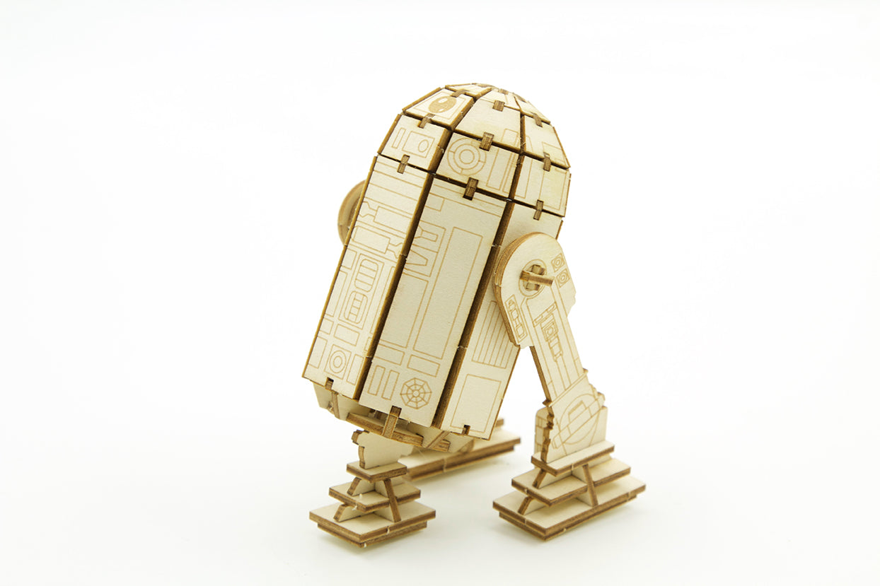 IncrediBuilds Star Wars R2-D2 3D wood model kit with instruction book, featuring detailed R2-D2 design and wooden assembly pieces.