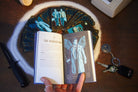 Supernatural Tarot Deck and Guidebook kit by Insight Editions, featuring illustrated tarot cards and accompanying guidebook on a wooden table.