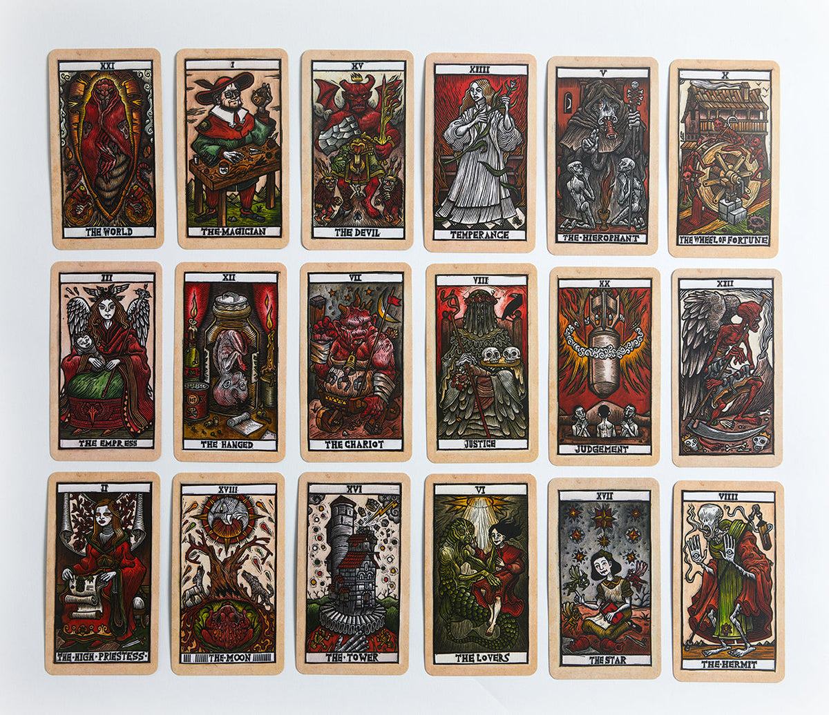 Inside view of the Tarot del Toro kit by Insight Editions, featuring tarot cards and guidebook laid out on a surface.