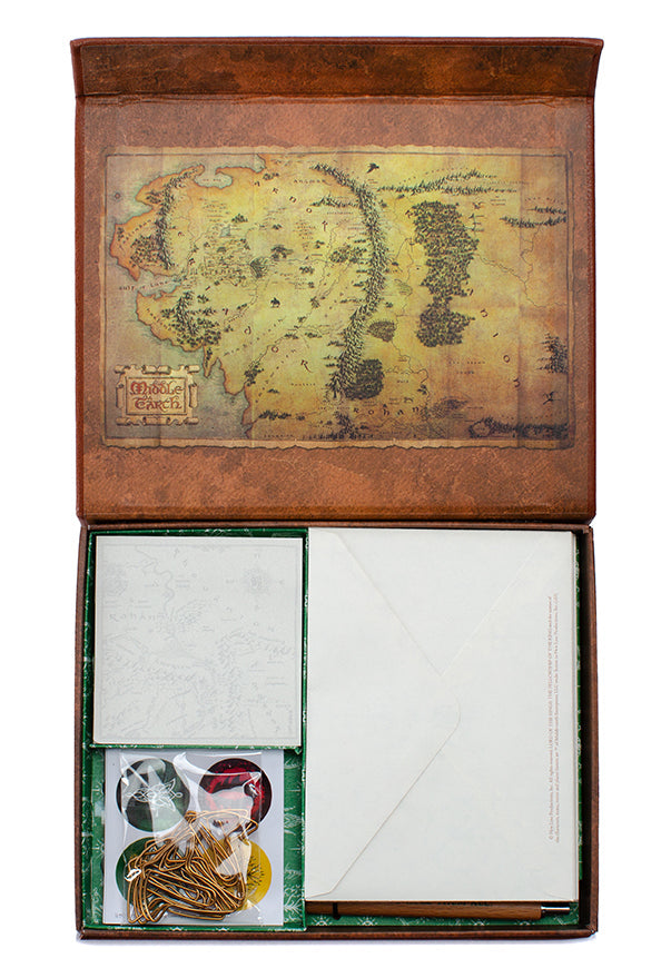 Inside view of Insight Editions' The Lord of the Rings: One Ring stationery kit featuring themed pens, paper, and accessories.