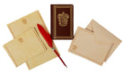 Gryffindor Harry Potter desktop stationery set with pen, featuring themed paper, notepad, and decorative accessories from Insight Editions.
