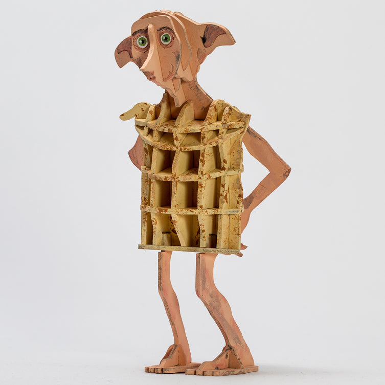 IncrediBuilds Harry Potter Dobby 3D wood model kit with booklet, featuring Dobby's detailed wooden figure and assembly instructions.