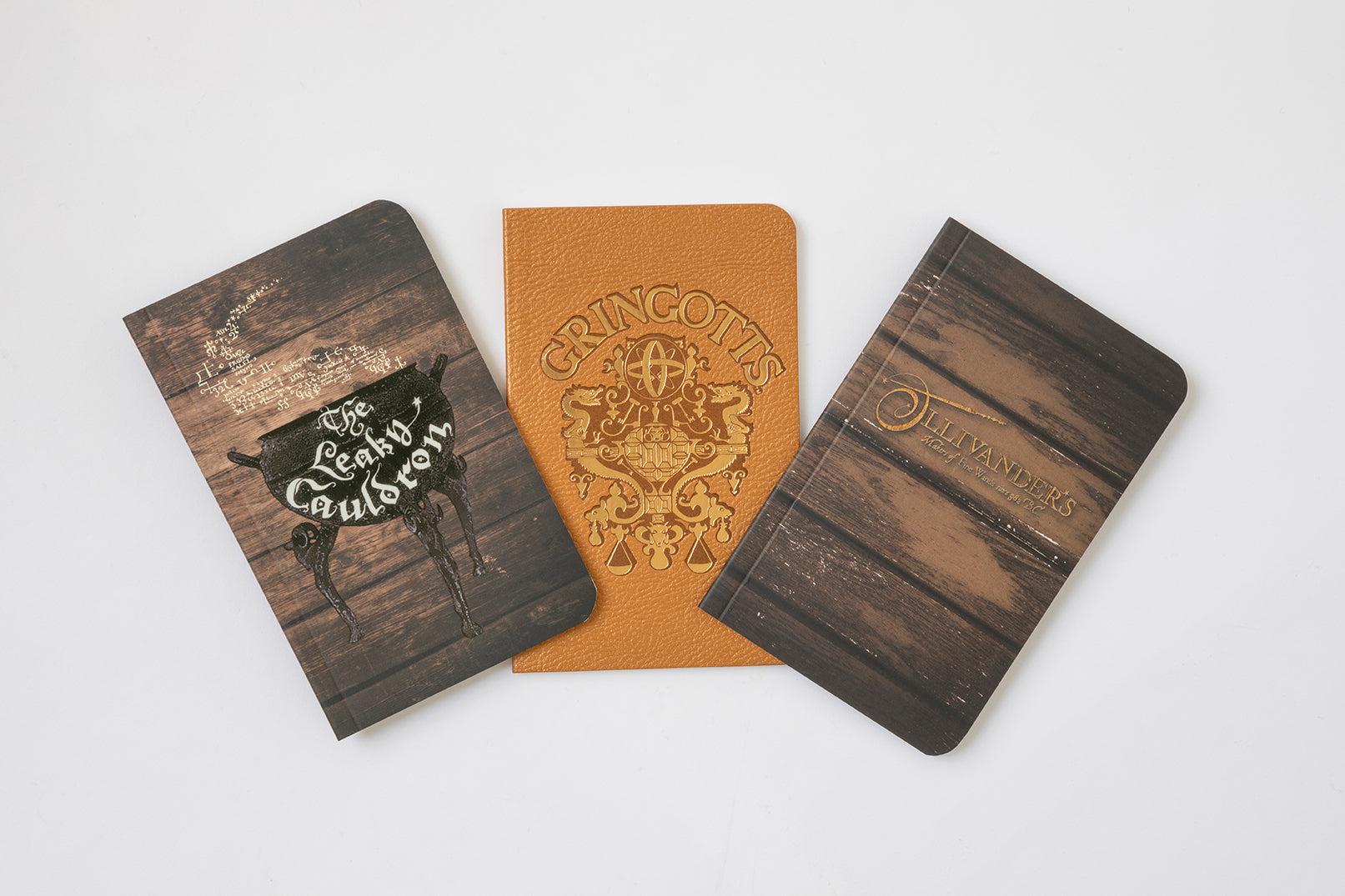 Set of three Harry Potter Diagon Alley softcover pocket notebooks by Insight Editions, featuring magical-themed covers.