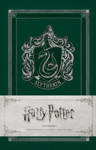 Softcover Harry Potter Slytherin ruled notebook by Insight Editions with green Slytherin crest and lined pages visible.