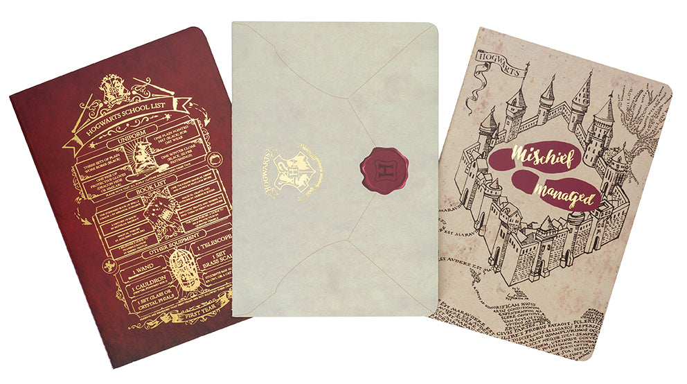 Set of three Harry Potter Welcome to Hogwarts softcover planner notebooks by Insight Editions, featuring magical wizarding world covers.