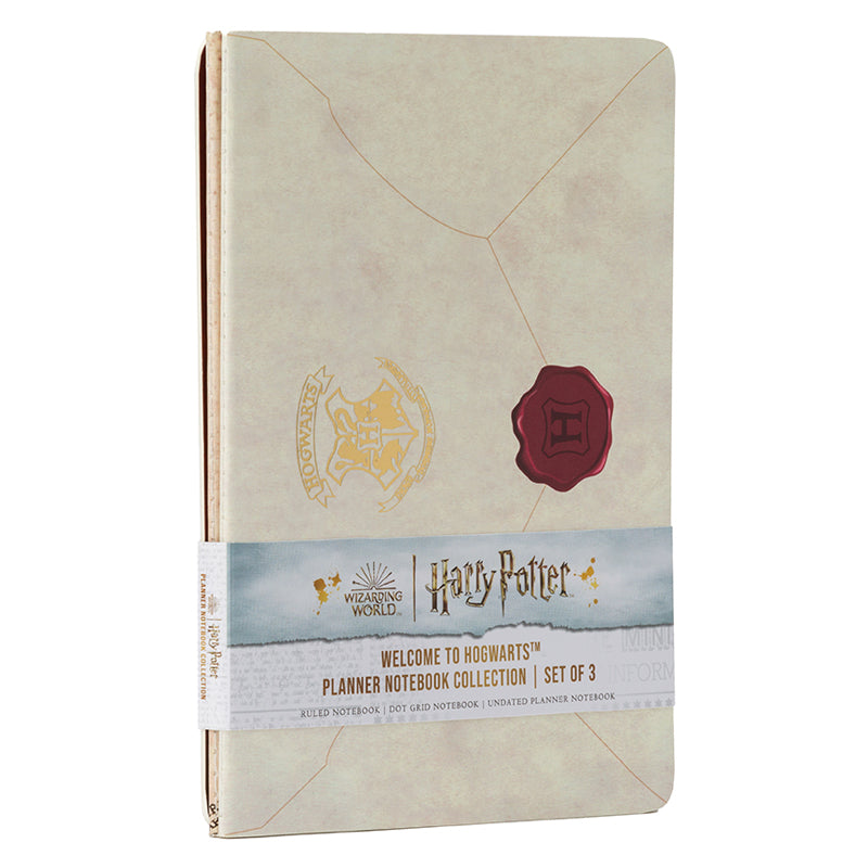 Set of three softcover Harry Potter Welcome to Hogwarts planner notebooks by Insight Editions with magical-themed covers.