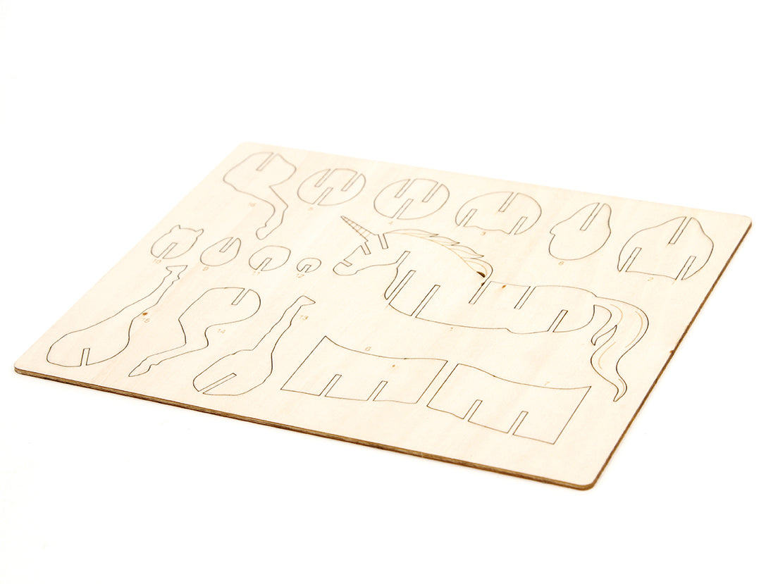 Softcover IncrediBuilds Unicorn book and 3D wood model by Insight Editions, featuring a colorful unicorn illustration and assembling components.