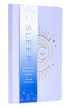 Softcover book titled "Sleep" by Insight Editions, featuring a calming cover design, lying open on a wooden surface.