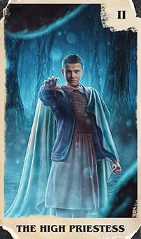 Inside view of the Stranger Things Tarot Deck and Guidebook by Insight Editions, featuring illustrated tarot cards and instructional pages.