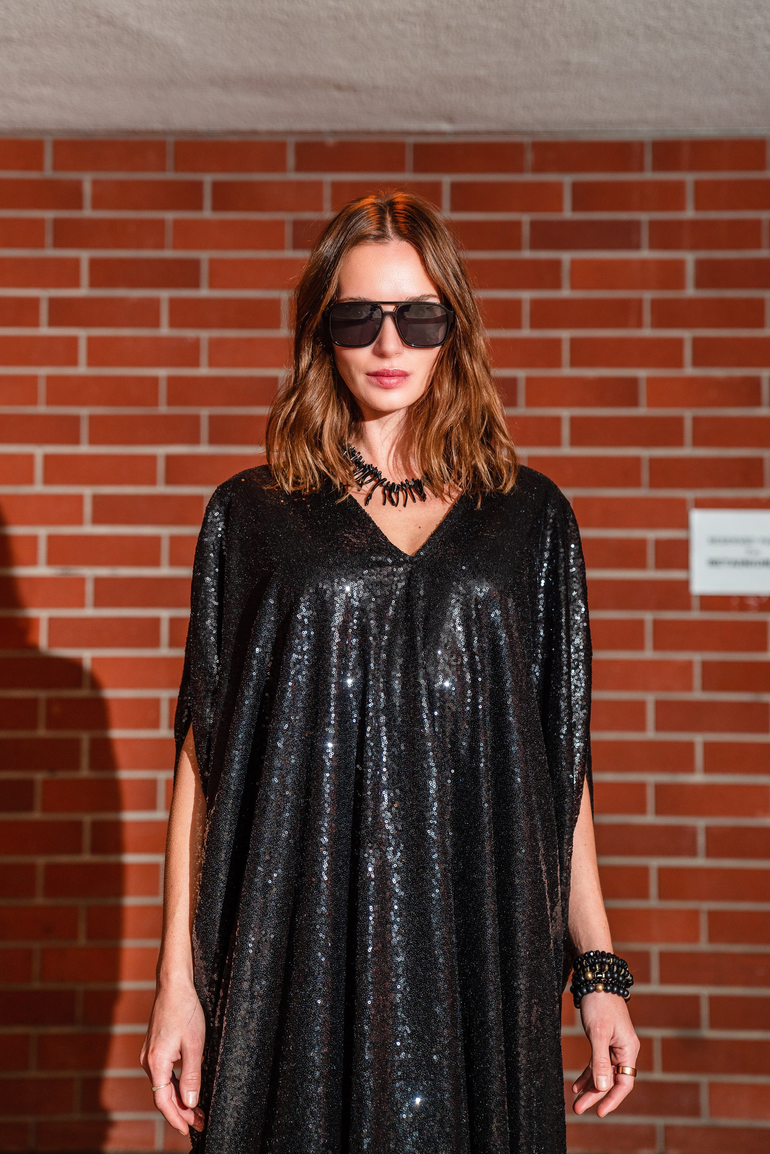 Black sequin caftan dress by Jennafer Grace featuring shimmering sequins and flowing silhouette, handmade for elegant style.