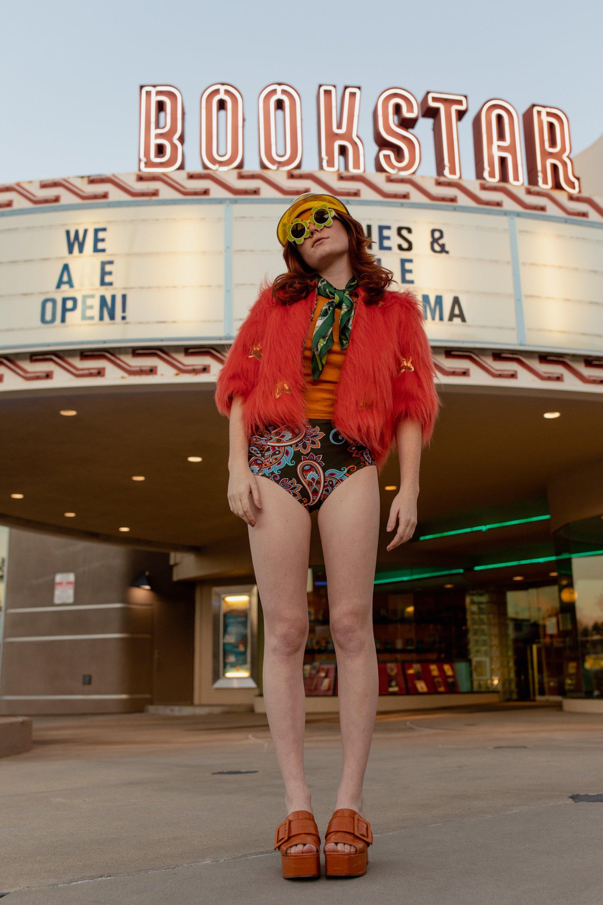 Jennafer Grace Planet Queen orange faux fur jacket on a girl, stylish and cozy outerwear with vibrant orange fur.