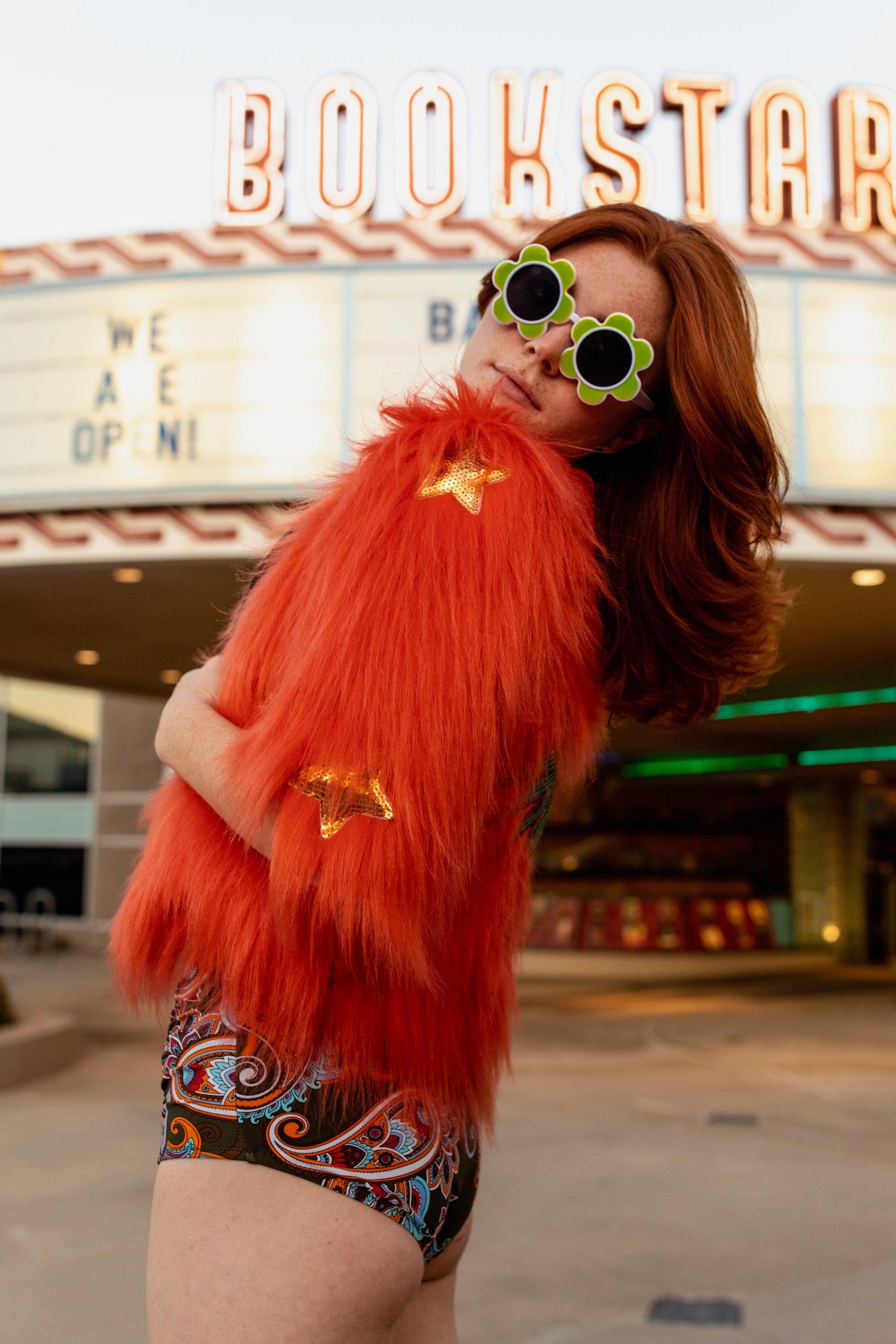 Jennafer Grace Planet Queen orange faux fur jacket on a girl, cozy and stylish winter outerwear with a plush texture.
