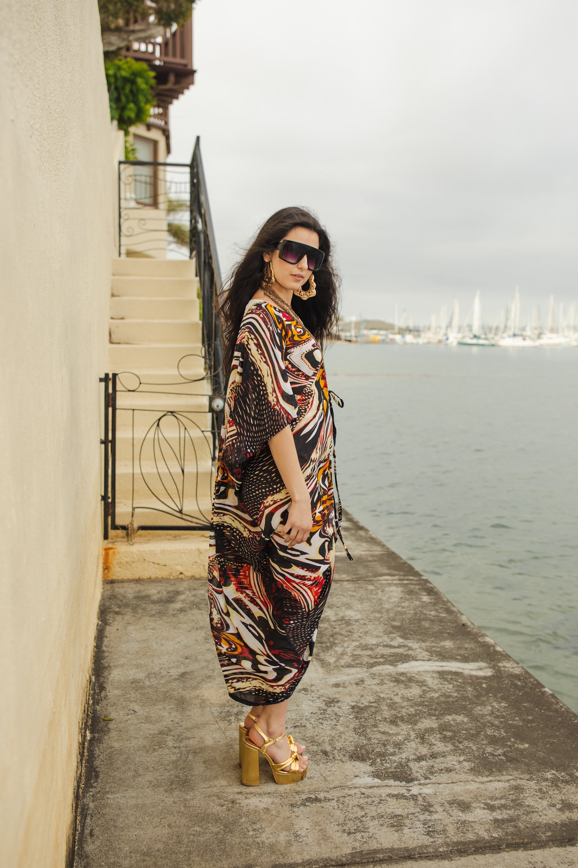 Handmade Jennafer Grace Actius Caftan dress in rich rouge fabric, featuring flowing design and elegant style.