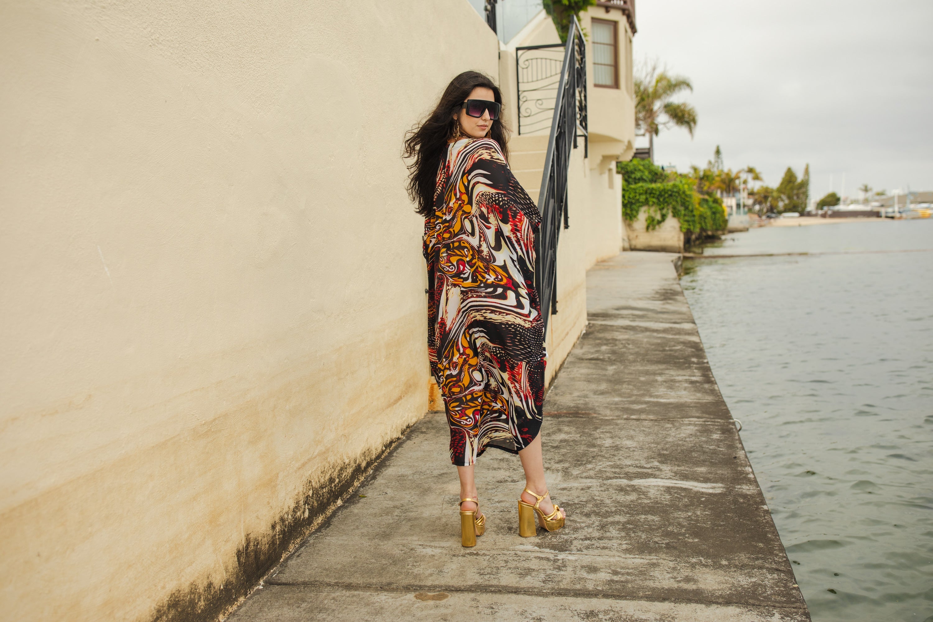 Handmade Jennafer Grace Actius Kaftan Dress in vibrant rouge with flowing fabric and intricate details.