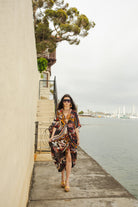 Handmade Jennafer Grace Actius Kaftan Dress in vibrant rouge, featuring flowing fabric and intricate design details.