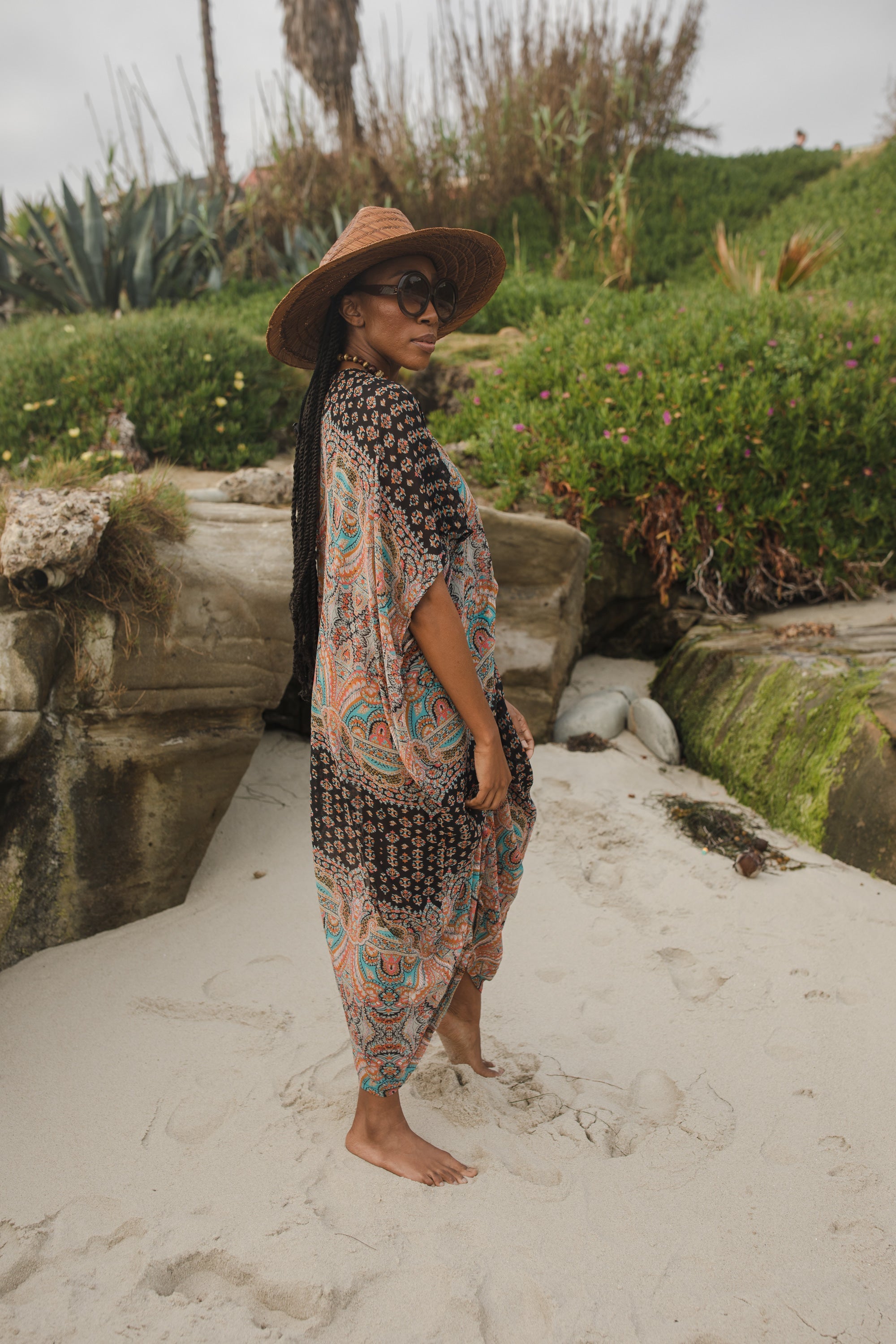 Jennafer Grace Actius Caftan in Taj, a flowing bohemian-style kaftan dress with intricate patterns and vibrant fabric.