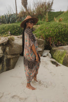 Jennafer Grace Actius Caftan in Taj, a flowing bohemian-style kaftan dress with intricate patterns and vibrant fabric.
