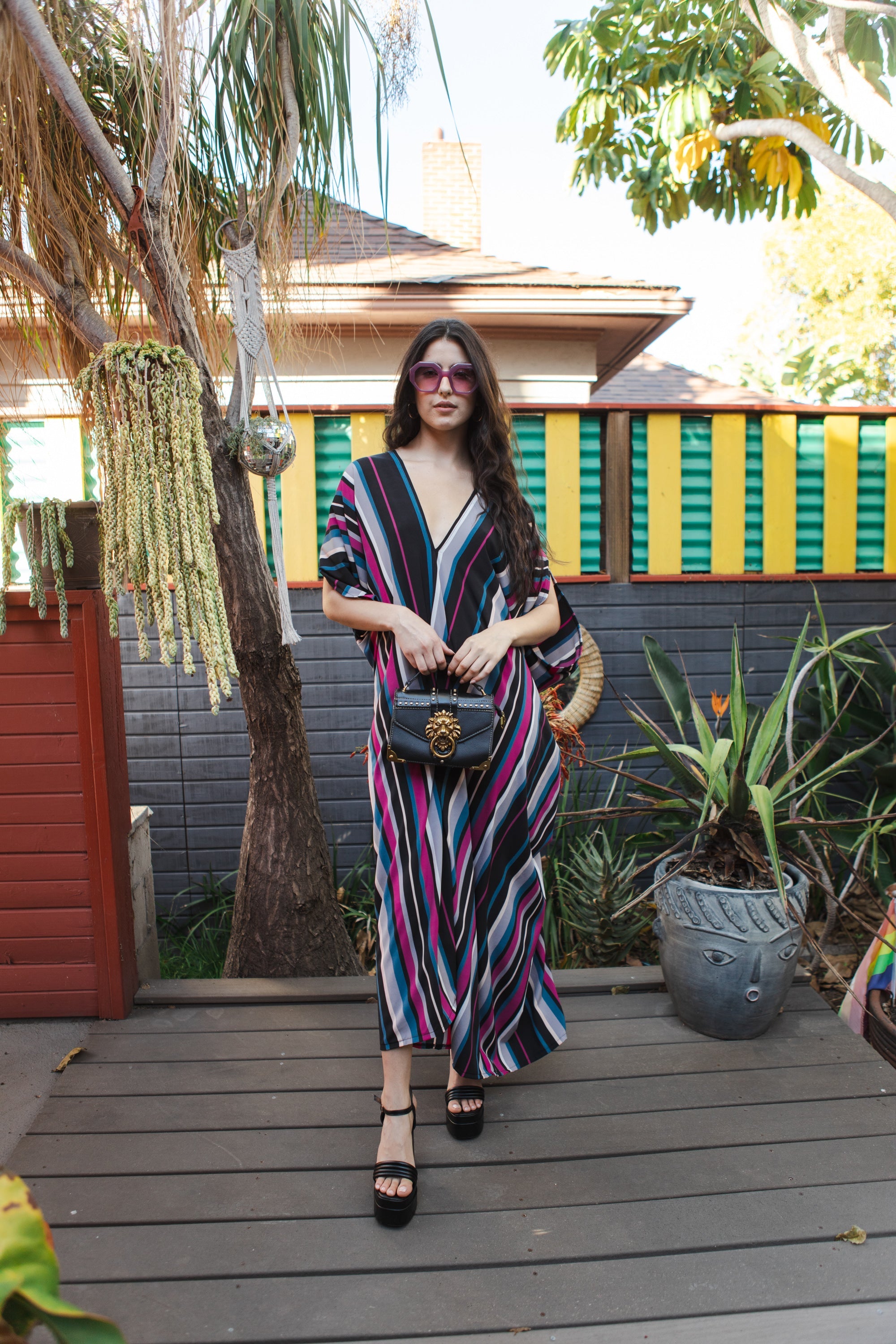 Raspberry stripe Jennafer Grace handmade kaftan dress with flowing fabric and vibrant pattern, displayed on a mannequin.