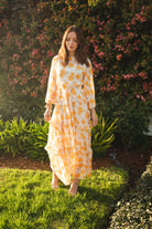 Jennafer Grace Amarillo Love Maxi Dress featuring vibrant yellow fabric, flowing design, and elegant fit on a model.
